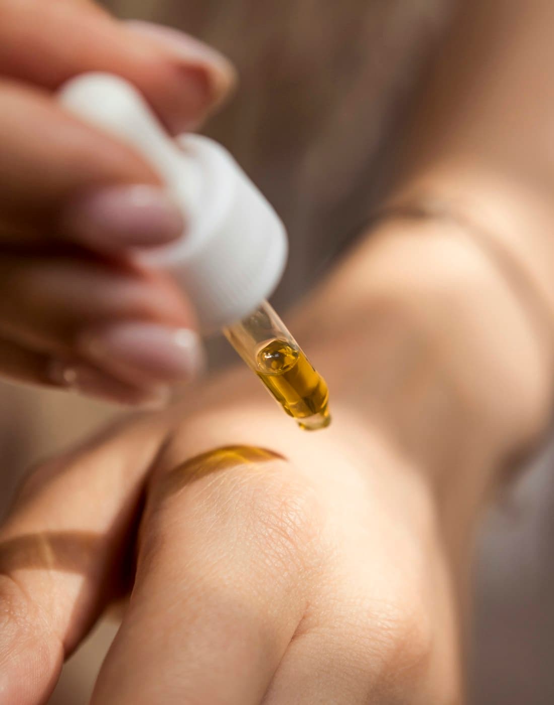 A few drops of body oil warmed on the back of a hand